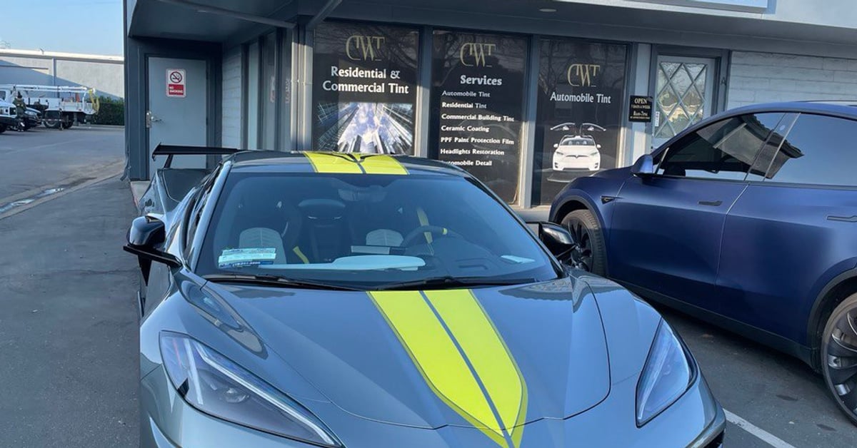 Grey Corvette C8 with yellow stripes parked in front of Deluxe Window Tinting shop in Gold River.